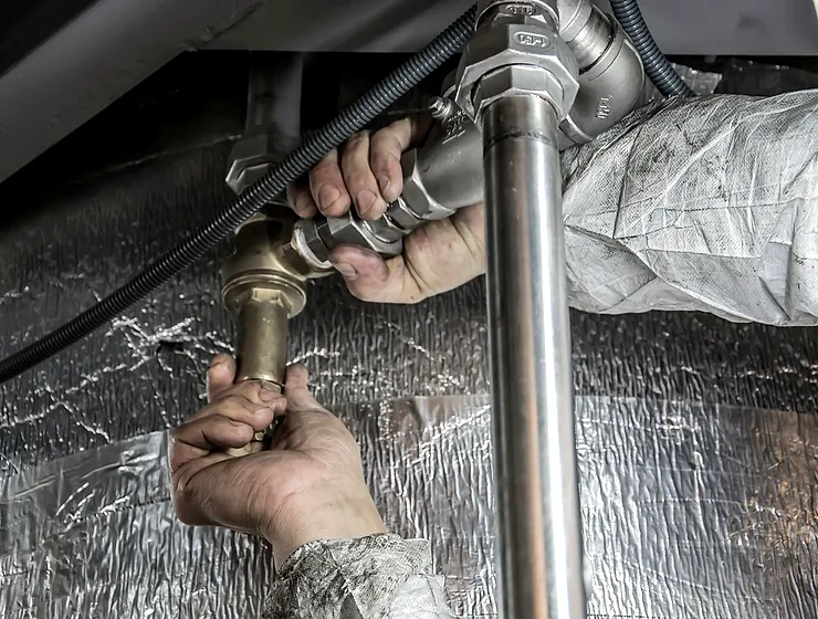 Plumber working on pipe fittings on an emergency callout